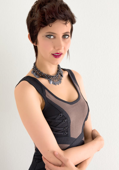 Glamour photo of a young woman wearing a tight black dress