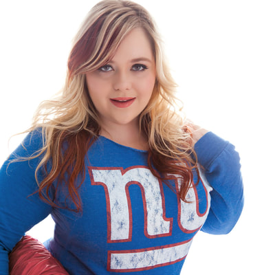 sexy portrait of a plus-size woman wearing a New York giants football jersey