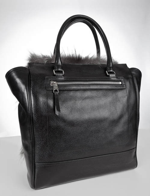 Back side featuring black leather and a zipper of the Coach Legacy Tanner Tote