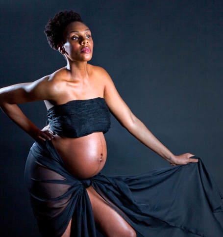 Beautiful pregnant black woman with her baby bump showing