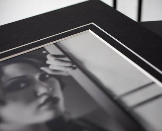 A portrait prig from a glamour or boudoir photo shoot inside a high quality matted frame