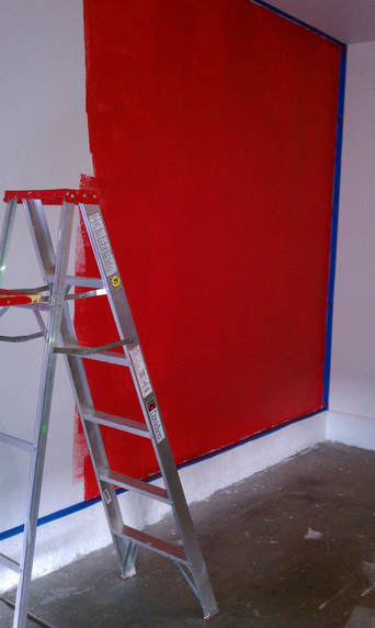 Designing a garage photography studio set by painting the wall red